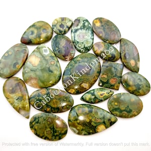 May include: A collection of 15 green, brown, and white ocean jasper cabochons. The cabochons are various shapes and sizes, including oval, teardrop, and rectangular.
