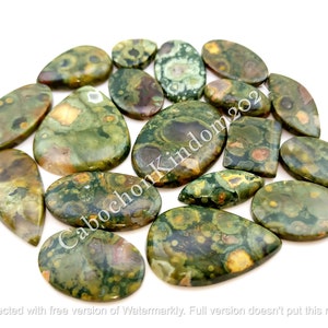 May include: A collection of 15 green, brown, and yellow ocean jasper cabochons. The cabochons are all different shapes and sizes, and they have a variety of patterns. The cabochons are all polished and have a smooth, shiny finish.