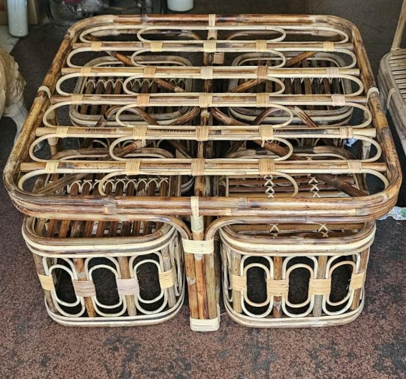 May include: A rectangular coffee table crafted from natural bamboo with a grid-like top surface. The table features four matching square stools tucked underneath, each constructed with a repeating oval pattern and light-colored binding.