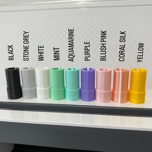 May include: A row of ten different colored vinyl rolls, including black, stone grey, white, mint, aquamarine, purple, blush pink, coral silk, and yellow.