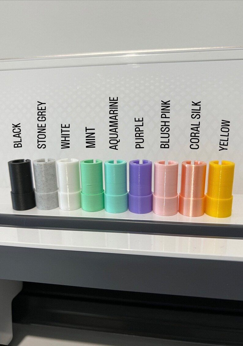 May include: A row of ten different colored vinyl rolls, including black, stone grey, white, mint, aquamarine, purple, blush pink, coral silk, and yellow.