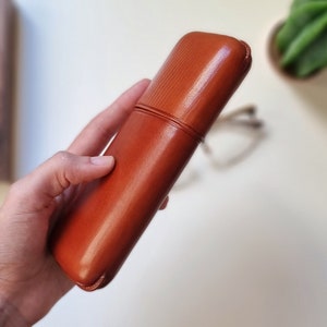 leather glasses case with a rigid frame and rounded edges to keep glasses protected