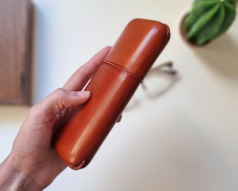 leather glasses case with a rigid frame and rounded edges to keep glasses protected