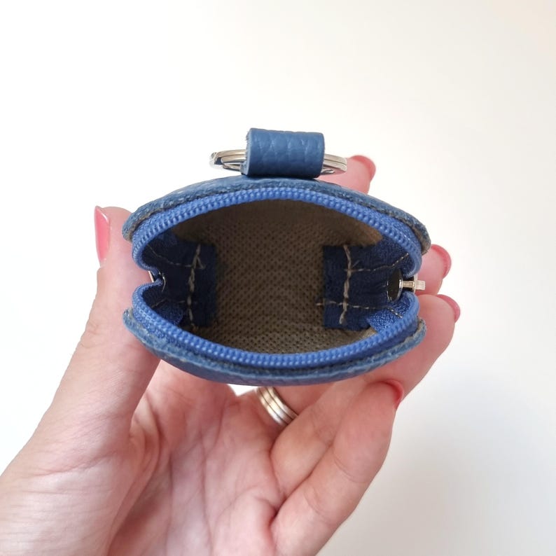 Interior view of leather pouch showing space for AirPods and small essentials