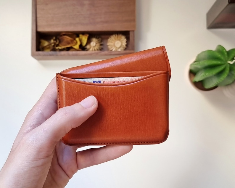 open leather card holder, shown up close and cards can be seen inside. This card holder is a high quality card holder with excellent finishes, perfect for gift.