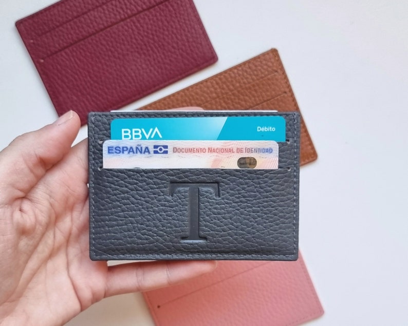Slim design leather card holder, the leather is very soft so it can hold a large number of cards. The card holder shown is gray in color and has the large initial T engraved in the center of the card holder.