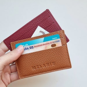 elegant design leather card holder, the leather is very soft so it can hold a large number of cards. The card holder shown is havana colored and has the name Melanie engraved in the center of the card holder.