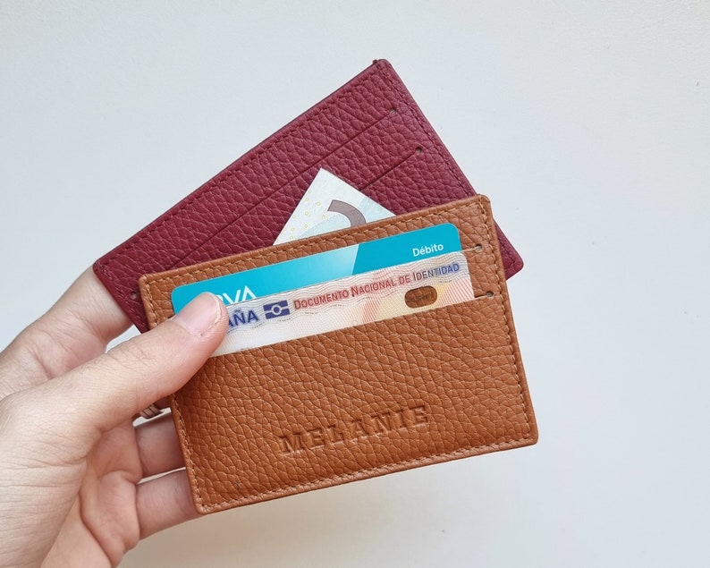 elegant design leather card holder, the leather is very soft so it can hold a large number of cards. The card holder shown is havana colored and has the name Melanie engraved in the center of the card holder.