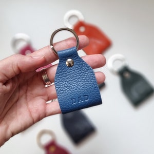 Full grain leather keychain in light blue color, engraved with the word Dad.