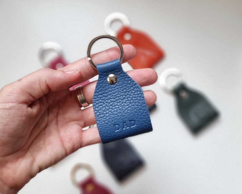 Full grain leather keychain in light blue color, engraved with the word Dad.