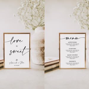 May include: Two gold framed signs, one with the text "love is sweet" and the names "Amanda & Steve" and the date "07.10.2023", and the other with the word "menu" and a list of appetizers, starters, main course, and desserts.