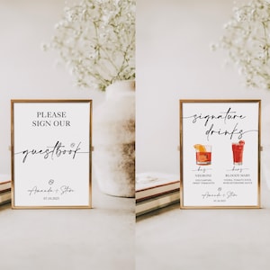 May include: Two gold framed signs with white backgrounds. The sign on the left says "Please sign our guestbook Amanda + Steve 07.10.2025". The sign on the right says "Signature drinks Negroni Gin, Campari, Sweet Vermouth Bloody Mary Vodka, Tomato Juice, Worcestershire Sauce Amanda + Steve 07.10.2025".
