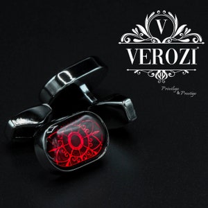 May include: Silver cufflinks with a red, ornate design. The cufflinks have a rectangular shape with a polished finish. The brand name "VEROZI" is displayed in white, along with the text "Privilege & Prestige".