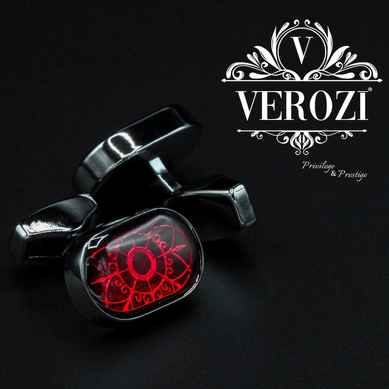 May include: Silver cufflinks with a red, ornate design. The cufflinks have a rectangular shape with a polished finish. The brand name "VEROZI" is displayed in white, along with the text "Privilege & Prestige".