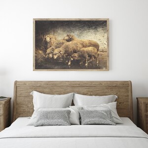 May include: A vintage-style print of a group of sheep huddled together in a barn. The sheep are brown and white, and the background is a dark, textured brown.