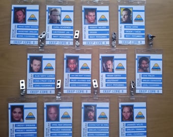 May include: A collection of Deep Core II identification badges. Each badge features a headshot, name, and role, with a blue and white design. The badges are for various personnel, including Navy and Benthic Petroleum employees.