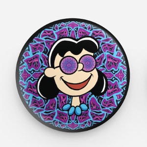 May include: A cartoon character with black hair and a blue necklace is wearing glasses with purple and blue mandala patterns. The character is smiling and has a purple and blue mandala background.