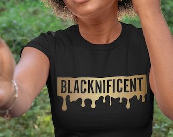 May include: Black t-shirt with a gold dripping graphic that says "BLACKNIFICENT".