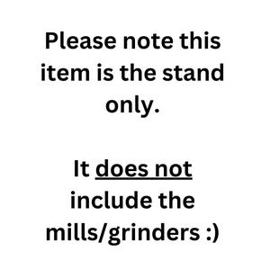 May include: A white graphic with black text that reads: Please note this item is the stand only. It does not include the mills/grinders :). This text serves as a clear notification regarding the product contents for the viewer.