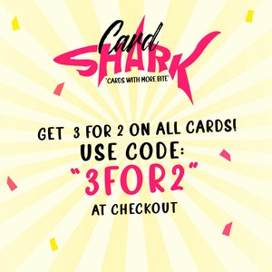 May include: A pink shark graphic with the text "Card Shark" and "Cards with More Bite" on a yellow background with white stripes. The text "Get 3 for 2 on all cards! Use code: "3FOR2" at checkout" is also included.