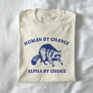 human by chance - unisex t shirt, meme t shirt, raccoon t shirt, raccoon shirt, weird graphic tee, funny t shirt, retro graphic tee