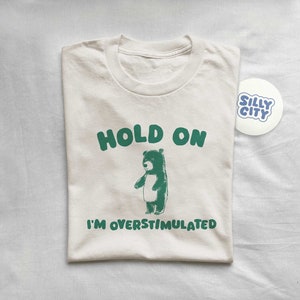 Hold On I'm Overstimulated - Unisex T Shirt