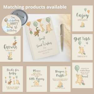 May include: A set of Winnie the Pooh themed party supplies for a baby shower or first birthday. The set includes a guest book, favor tags, a diaper raffle sign, a gift table sign, a button, and a sign that says "Enjoy some sweets".