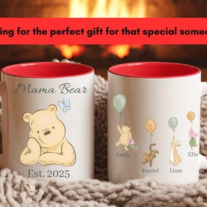 May include: Two white ceramic mugs with red interiors and handles. One mug features a Winnie the Pooh bear illustration with the text "Mama Bear" and "Est. 2025". The other mug has illustrations of Winnie the Pooh characters with names. The text "Looking for the perfect gift for that special someone?" is at the top.
