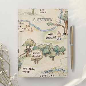 May include: A Winnie the Pooh themed guest book with a hand-drawn map of the Hundred Acre Wood. The map features locations like "My House", "Owl's House", "Bee Tree", "Eeyore's", and "100 Aker Wood".