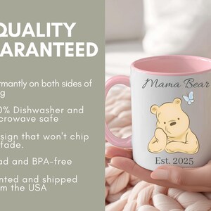 May include: White ceramic mug with a pink interior and handle. The mug features a cartoon bear illustration, the words "Mama Bear", a blue butterfly, and "Est. 2025". The mug is designed for durability.
