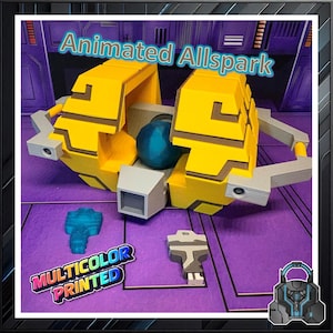 May include: A yellow and gray 3D-printed model of the Animated Allspark, with a blue sphere and two additional pieces. The model has the text "Animated Allspark" and "Multicolor Printed".