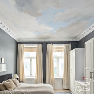 May include: A bedroom with a painted cloud ceiling, gray walls, and white trim. The room features cream-colored curtains, white cabinets, and a bed with beige bedding. The text "Vintage Murals" is visible on the cabinet.