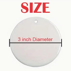May include: White round ceramic ornament with a 3 inch diameter. The ornament has a hole at the top for hanging.