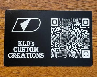 May include: Black and white business card with a white logo of a stylized letter D and the text "KLD's CUSTOM CREATIONS". A black and white QR code is on the right side of the card.
