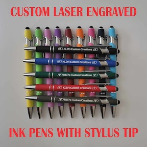 May include: A collection of ten ink pens with stylus tips, each featuring a different color and laser engraved with the text "KLD's Custom Creations".