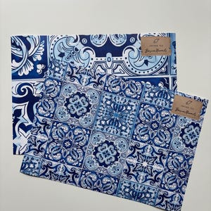 May include: Two sheets of blue and white patterned wrapping paper with a brown label that reads "Vintage Tile, Bazaar Murals, 67".