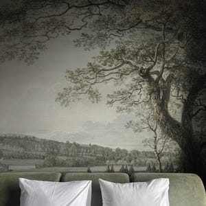 Puede incluir: Una cabecera de terciopelo verde con dos almohadas blancas y un mural de paisaje verde y gris con un gran árbol en el fondo. El texto "Bosco Murals" es visible en la esquina inferior derecha de la imagen.
