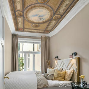 May include: A bedroom featuring a decorative ceiling mural with a central circular painting of a sky scene. The room has a bed with a diamond-patterned headboard, neutral-toned bedding, and a window with beige curtains. The text "Bosco Murals" is visible.