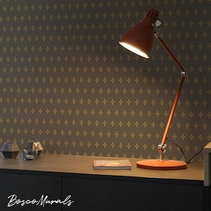 May include: A white ceramic mug with a black handle and the text "But First, Coffee" in a bold, black font. The mug is set against a blurred background, suggesting a cozy setting.