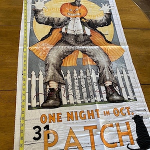 May include: A Halloween-themed fabric panel featuring a pumpkin-headed figure in a suit, with the words "Pumpkin Patch" and "One Night in Oct." printed in orange. The panel is approximately 42 inches long.