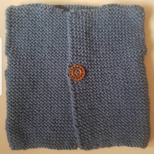 Handknitted baby waistcoat with front button fastening.