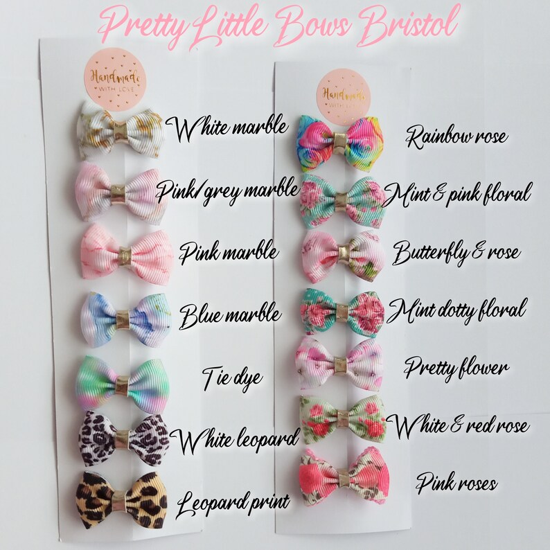 May include: A set of 10 pairs of handmade hair bows with various patterns and colors, including white marble, pink marble, blue marble, tie dye, leopard print, rainbow rose, mint and pink floral, butterfly and rose, mint dotty floral, and white and red rose. The bows are displayed on a white card with the text "Pretty Little Bows Bristol" at the top.