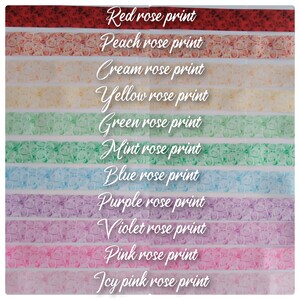 May include: A collection of 12 washi tapes featuring different colored rose prints. The tapes are arranged in a rainbow pattern, starting with red and ending with icy pink.