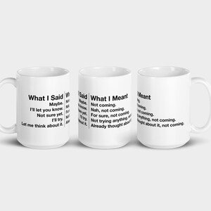 May include: Three white ceramic mugs with black text. The mugs display the phrases "What I Said," "What I Meant," and "What I Meant" with humorous statements. The mugs are ideal for coffee, tea, or any beverage.