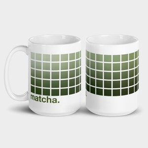 May include: Two white ceramic mugs with a green gradient pattern and the word "matcha." printed on one mug.