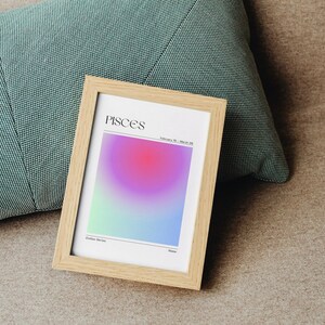 May include: A framed print with a gradient background in shades of blue, green, pink, and purple. The print features the word "Pisces" in black text and the dates "February 19 - March 20".