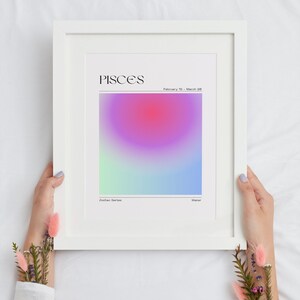 May include: A white framed print with a gradient background in shades of pink, purple, blue, and green. The text "PISCES" is at the top of the print, with the dates "February 19 - March 20" below. The words "Zodiac Series" and "Water" are at the bottom of the print.