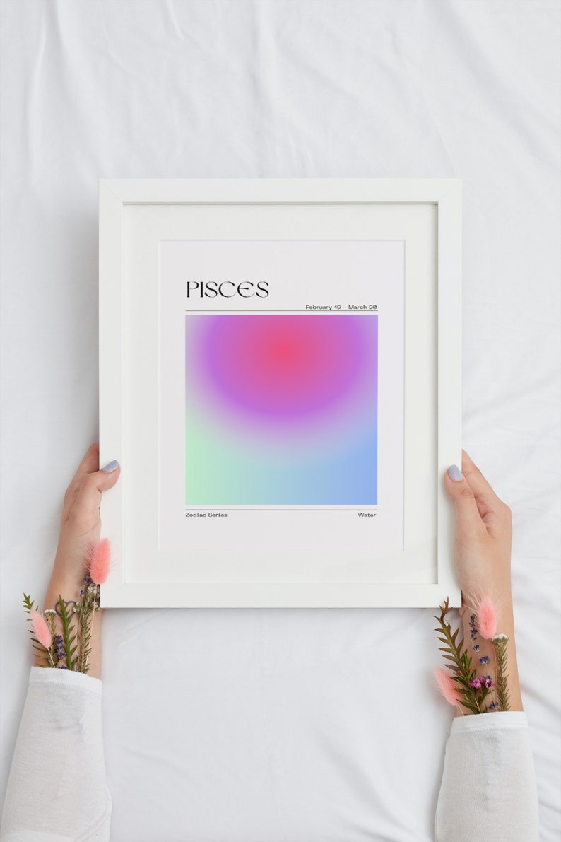 May include: A white framed print with a gradient background in shades of pink, purple, blue, and green. The text "PISCES" is at the top of the print, with the dates "February 19 - March 20" below. The words "Zodiac Series" and "Water" are at the bottom of the print.