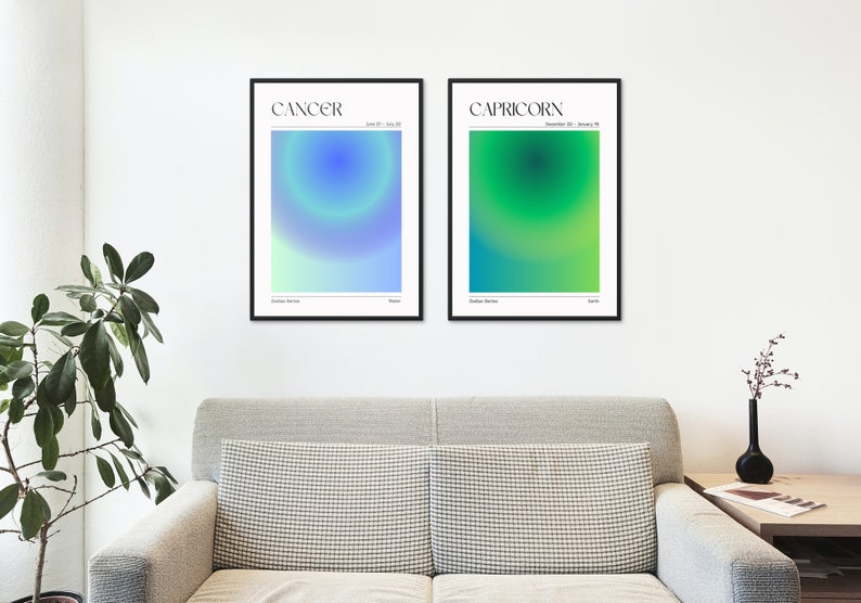 May include: Two framed posters with a gradient background. The poster on the left is blue and green and says "CANCER June 21 - July 22". The poster on the right is green and yellow and says "CAPRICORN December 22 - January 19".
