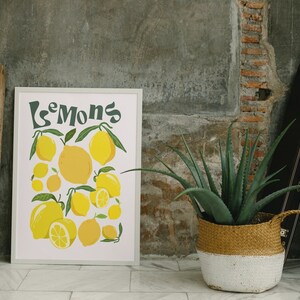 May include: A framed print with a white background and the word "Lemons" in green text. The print features a colorful illustration of lemons with green leaves.